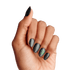 A hand with almond-shaped black matte nails featuring subtle sparkles, with the ring fingernail displaying a small green \