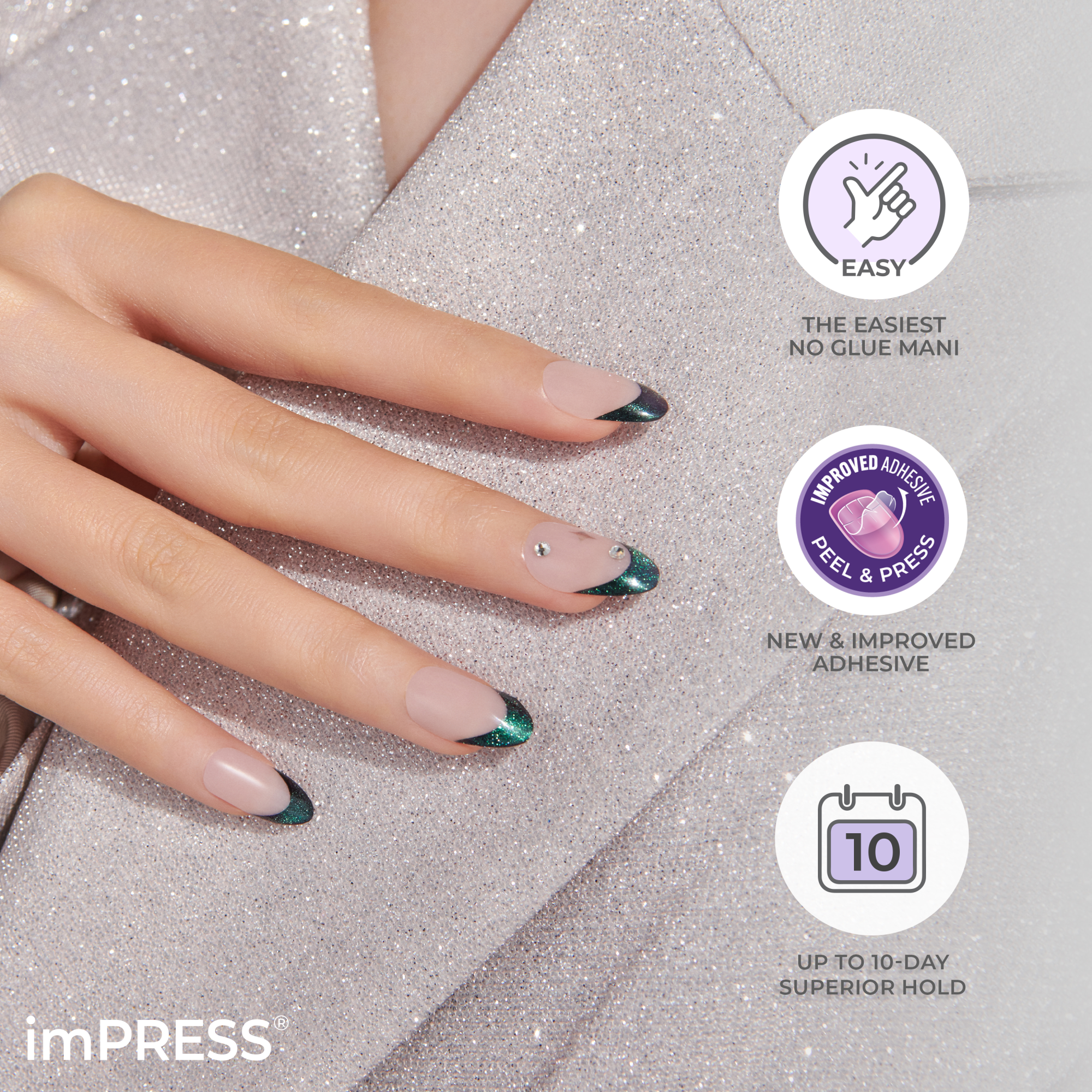 Hand with matte nude press-on nails featuring dark green glittery tips and small rhinestones on a sparkly silver surface, highlighting easy application, improved adhesive, and up to 10-day hold.