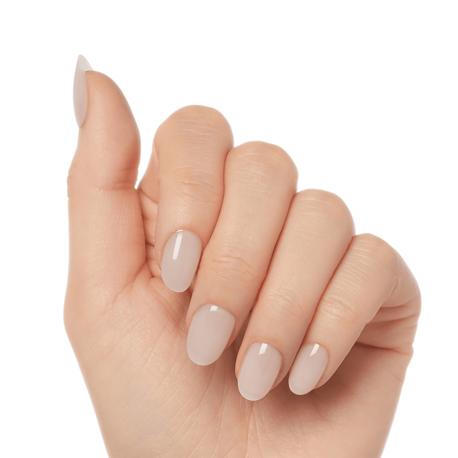 Hand with natural-looking, oval-shaped press-on gel nails in a soft nude beige color, shown from a side angle with fingers slightly curled.