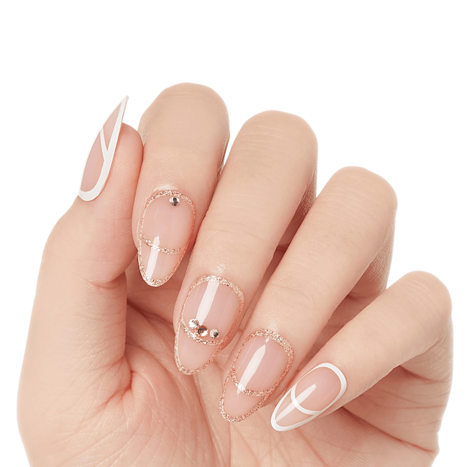 Hand with press-on nails featuring a nude base, rose gold glitter lines, silver rhinestones on middle nails, and white geometric designs on thumb and pinky.