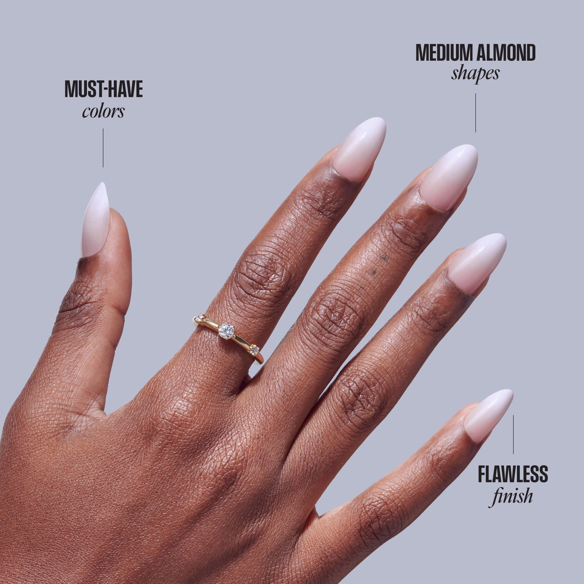 Medium almond nails with pink and white ombre finish on dark skin tone hand with diamond ring.