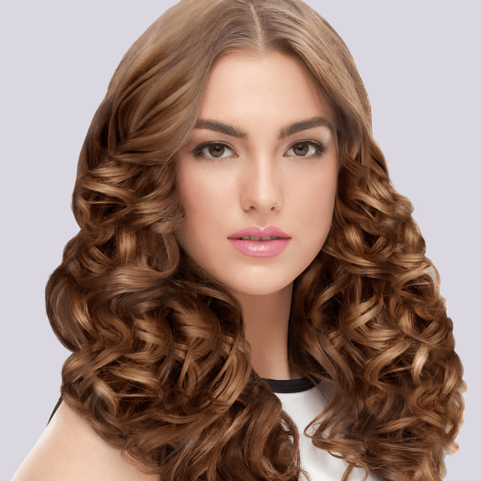 Woman with long, shiny light brown hair styled in voluminous, defined 1-inch curls against a plain light gray background.