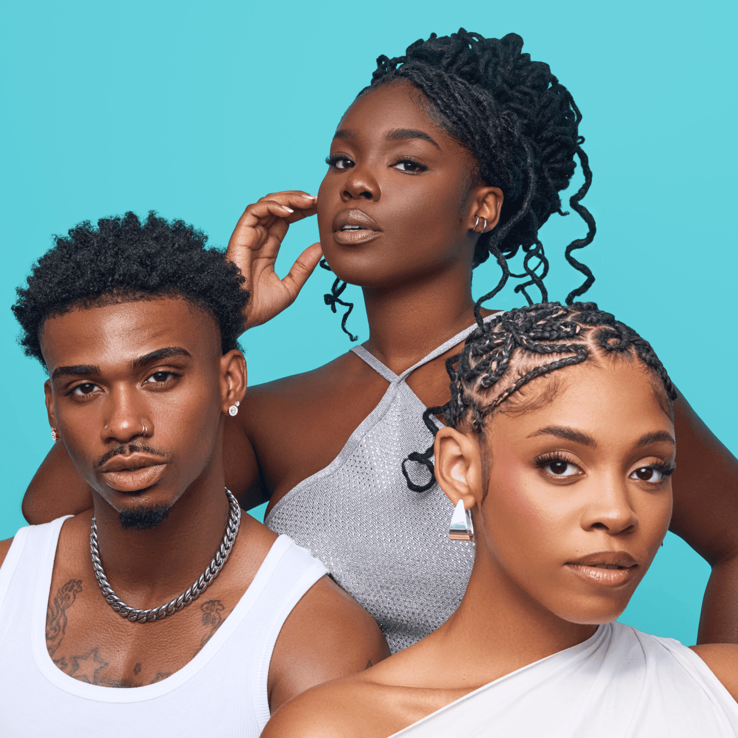 Three diverse models with natural hairstyles pose against a blue background, showcasing healthy hair and vibrant skin, promoting KISS Colors &amp; Care Multivitamin Oil.