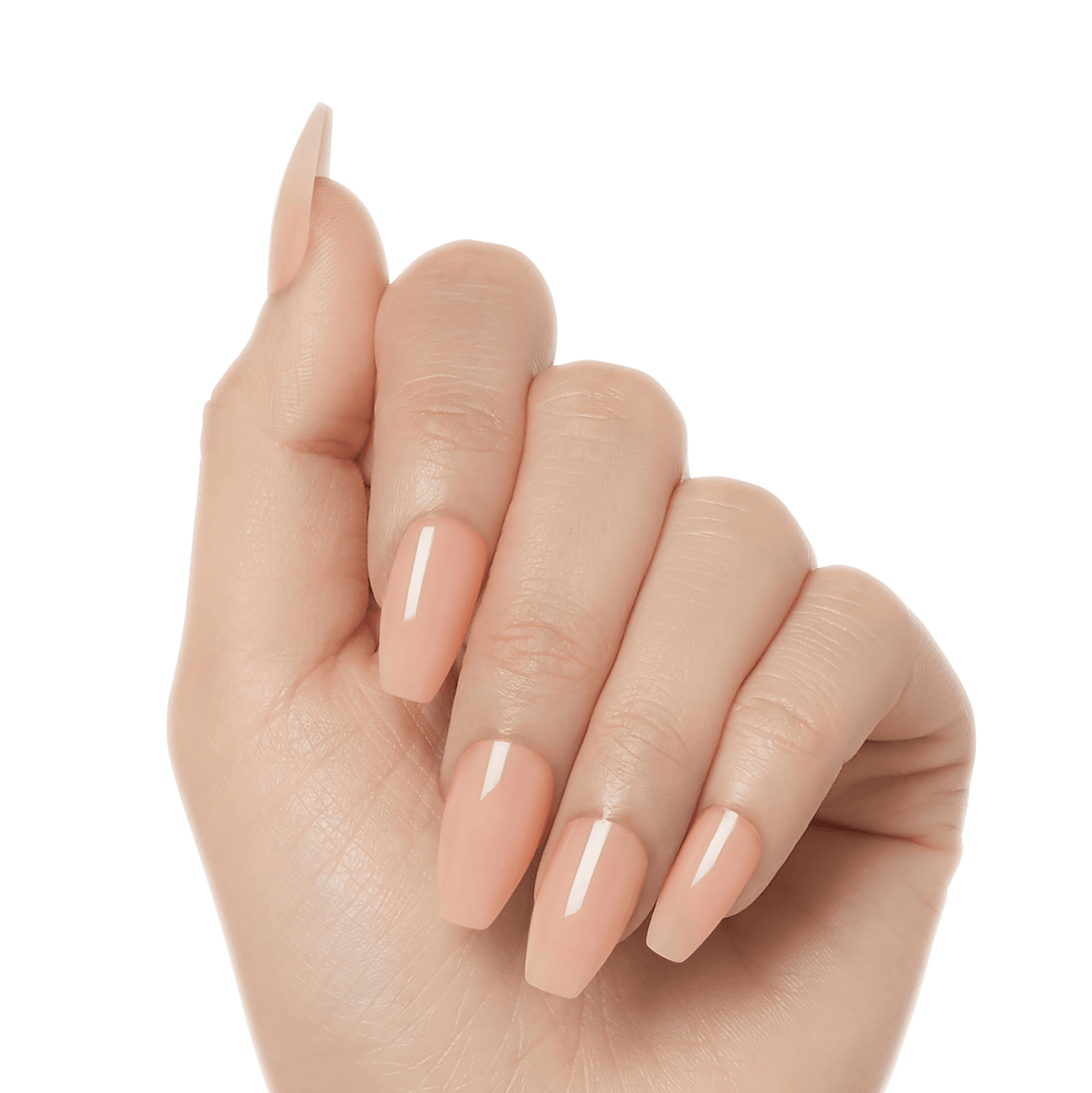 Glossy, press-on gel nails in a soft peach nude shade named Limousine, shaped in a long coffin style on a hand with natural skin tone.