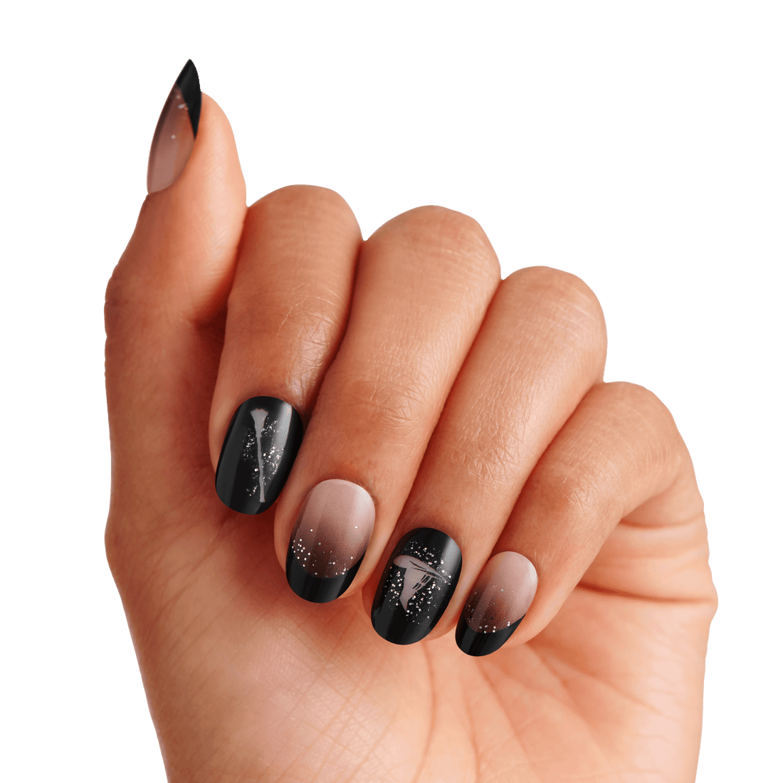 Black and nude ombre nails with glitter accents on model hand