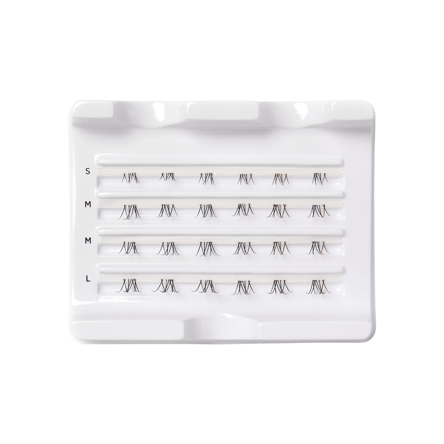 Tray of FALSCARA Wisps Multipack bottom lash clusters in four sizes—small, medium, and large—arranged in rows on white plastic.
