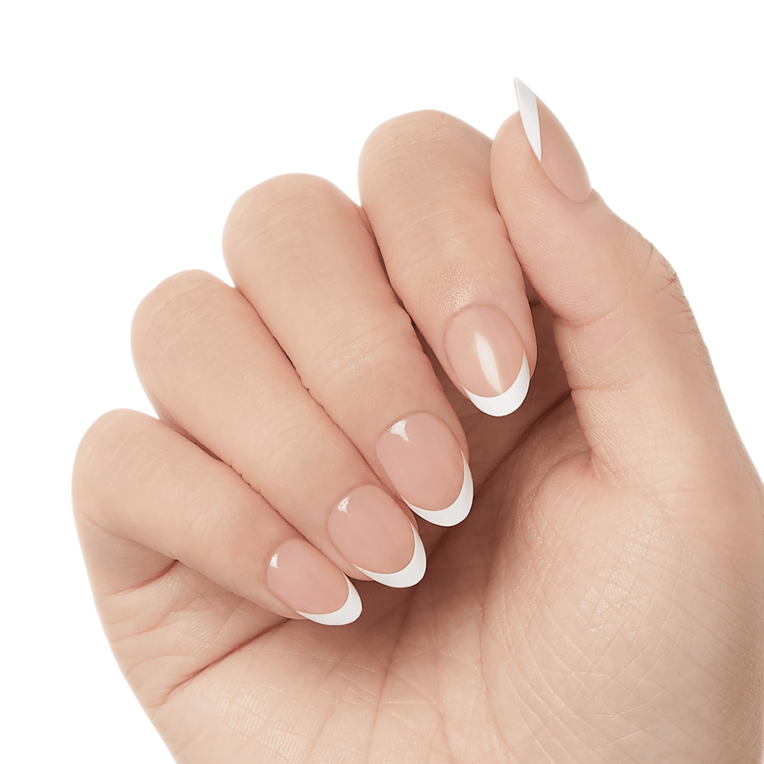 Hand with press-on gel nails in a natural nude shade featuring white French tips in varied almond and coffin shapes.