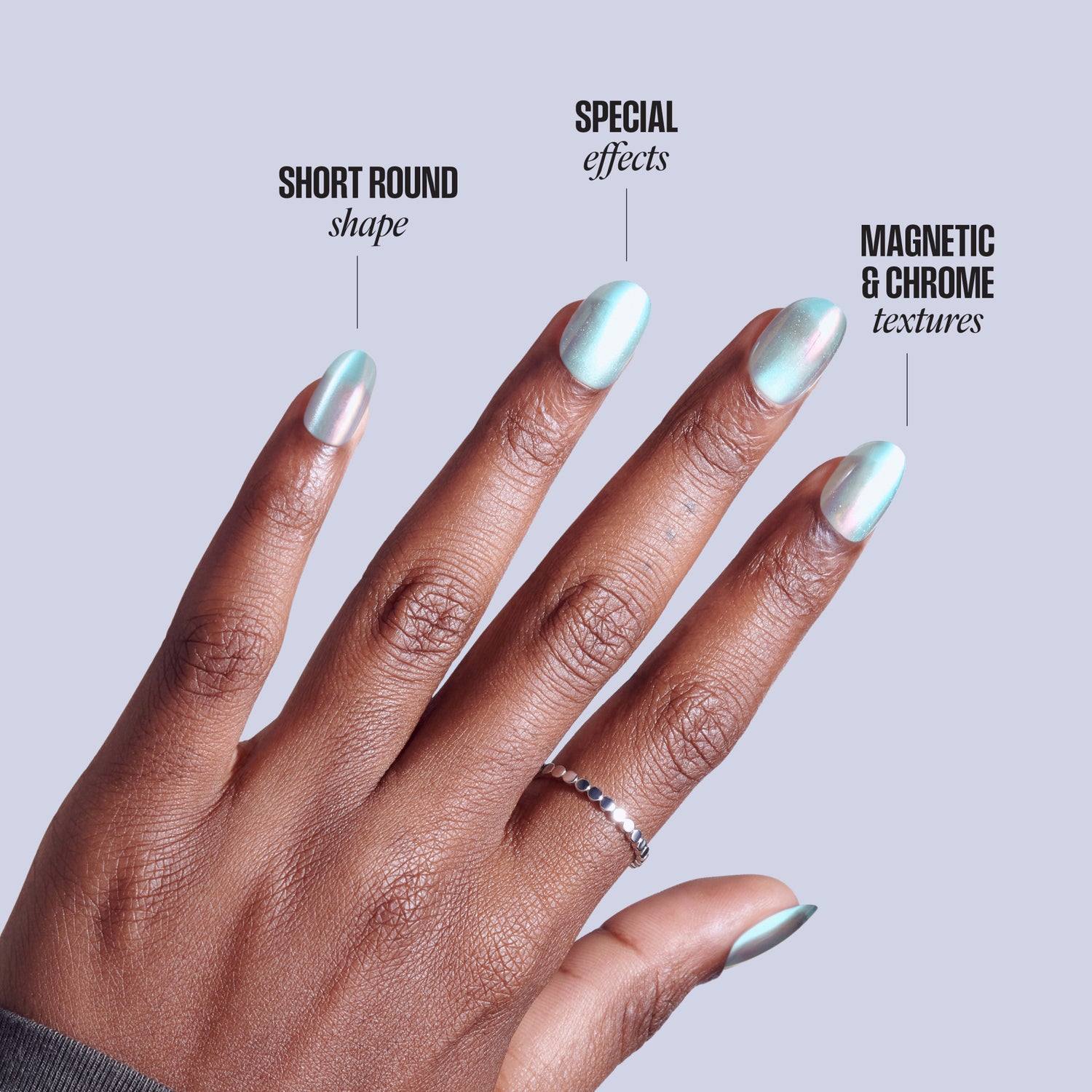Hand displaying short round nails with magnetic chrome textures and special effects finish.