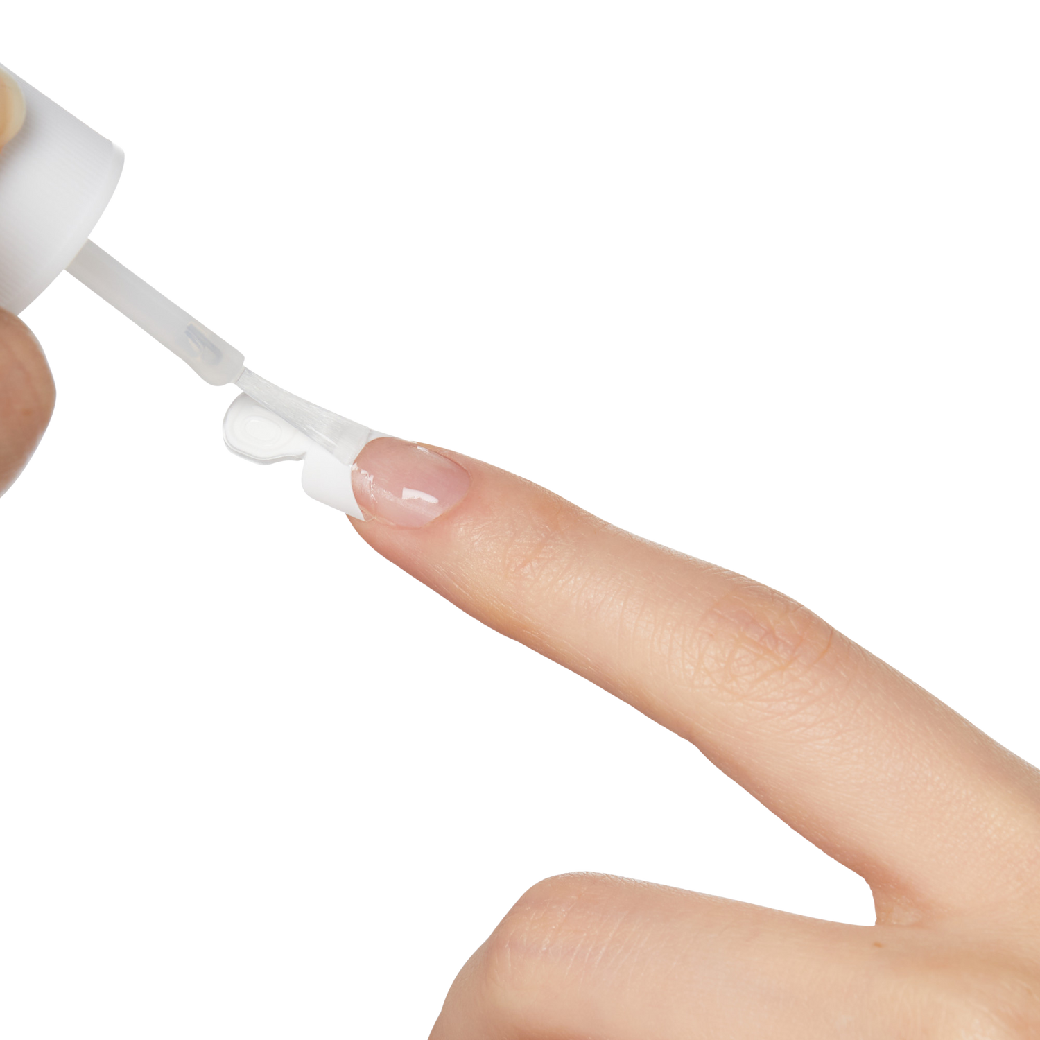 Close-up of a hand applying clear gel polish with a brush onto the tip of a fingernail, demonstrating the KS Brush-On Gel Nail Kit in use.