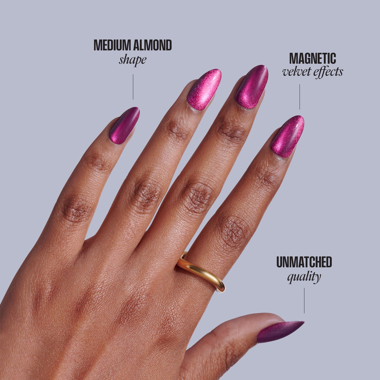 Magenta nail polish on medium almond nails with magnetic velvet effects and gold ring.