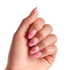 Hand showing five oval-shaped press-on nails with a pink ombré design, two nails featuring small silver bow accents with a central gem.