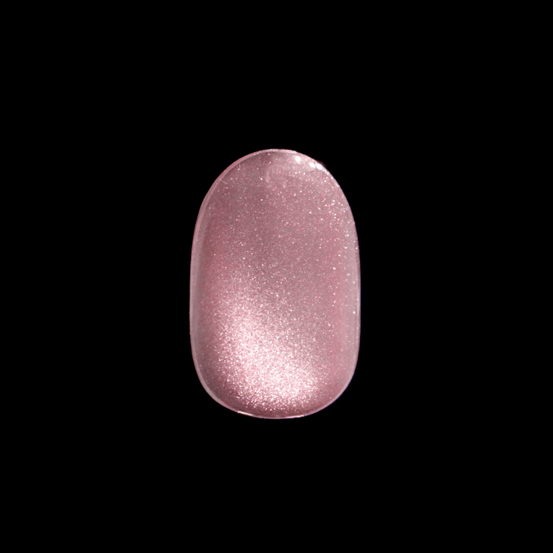 Glossy, oval-shaped press-on nail in a shimmering pink shade with a subtle starry glitter effect, shown against a black background.